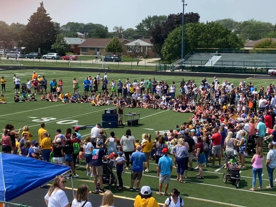 A school assembly with dozens of students watching the reptile presentation